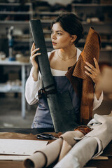 Woman tailor working on leather fabric