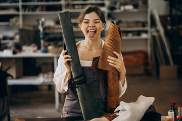 Woman tailor working on leather fabric