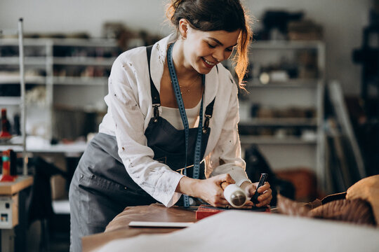 Woman Tailor Working On Leather Fabric