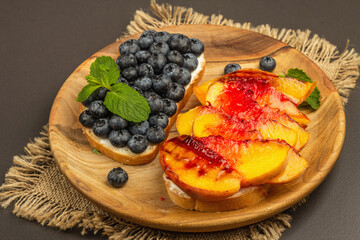 Tasty toast bread with cream cheese and ripe fruits