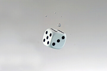 Dice falling into the water with splashes