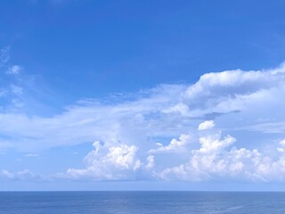 Naklejka na ściany i meble Sea and sky clouds. Blue sea water. Beautiful cloudscape.