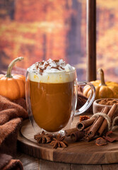 Pumpkin spice latte with autumn background