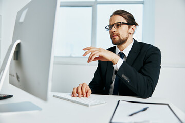 male manager an official is working at the computer Chief