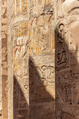Massive columns after reconstruction inside beautiful Egyptian temple in Luxor with hieroglyphics, and ancient symbols. Karnak temple.