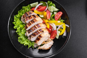 chicken salad vegetables, chicken breast grill fresh portion ready to eat meal snack on the table copy space food background rustic. top view keto or paleo diet