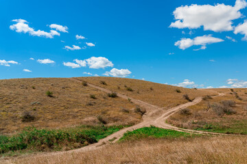 Beautiful landscape of mountainous terrain with hills against a blue sky with clouds