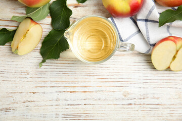 Natural apple vinegar and fresh fruits on white wooden table, flat lay. Space for text