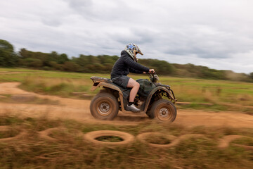 A young boy quad biking on the dusty hills of South Wales © Paul