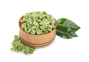 Wooden bowl with green coffee beans and fresh leaves on white background