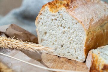 Freshly baked loaf of bread on a wooden board.