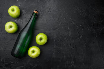 Apple cider bottle, on black dark stone table background, top view flat lay, with copy space for text