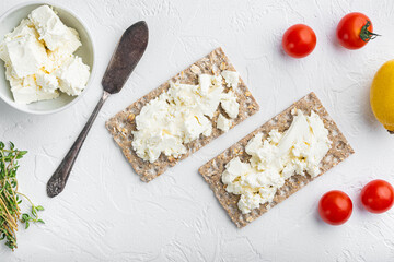Homemade Crisp bread toast with Cottage Cheese, on white stone table background, top view flat lay,...
