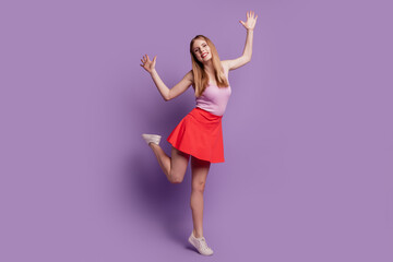 Portrait of carefree party disco dancer lady dance have fun wear pink top red short skirt on violet background