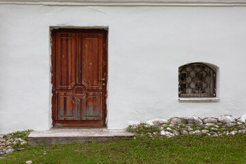 Entrance wooden brown  door in the white wall
