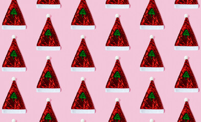 Fototapeta na wymiar Seamless pattern with Santa Claus hat made of sequins on a pink background. Сoncept of holiday, Christmas and New Year