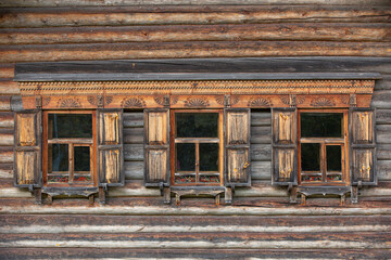 Three opened windows of old wooden building