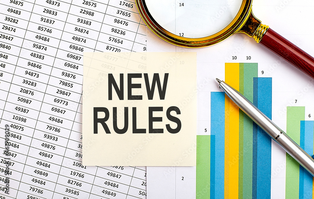 Aufkleber business concept. top view of stiscker with text new rules on chart background