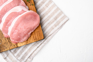 Pork steaks Raw meat, on white stone table background, top view flat lay, with copy space for text