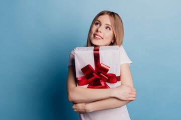 Photo of dreamy adorable blonde lady cuddle special gift look up empty space dream on blue color...