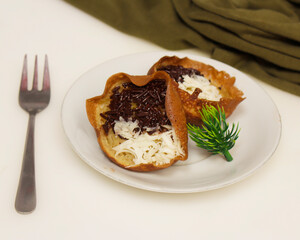 Mini moonlit cake with chocolate and cheese topping. This cake is very easy to find along the roadside. This cake is suitable to be eaten at night as a snack with the family. Focus blur.