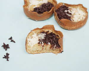 Mini moonlit cake with chocolate and cheese topping. This cake is very easy to find along the roadside. This cake is suitable to be eaten at night as a snack with the family. Focus blur.