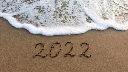 Fototapeta premium New Year 2022 is coming concept on tropical beach.