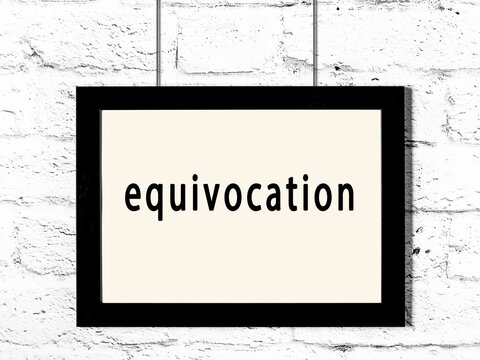 Black frame hanging on white brick wall with inscription equivocation