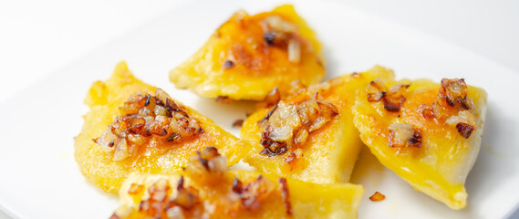 Fried dumplings sprinkled with fried onion, traditional Polish, Russian and Ukrainian cuisine