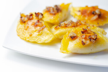 Fried dumplings sprinkled with fried onion, traditional Polish, Russian and Ukrainian cuisine