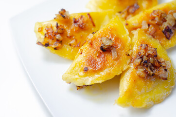 Fried dumplings sprinkled with fried onion, traditional Polish, Russian and Ukrainian cuisine