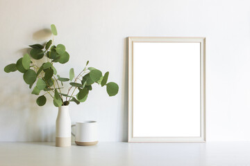 An empty white frame with organic flower with nature light. 