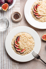 Risotto  made with taleggio cheese, rosemary and fresh figs. Italian dinner. Vegetarian rice dish. Vertical image.