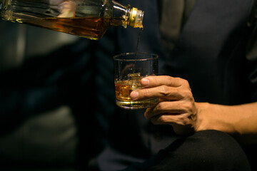 Businessmen in suits drinking whiskey