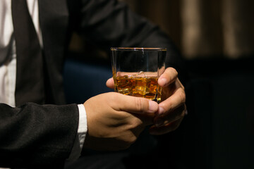 Businessmen in suits drinking whiskey