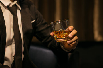 Businessmen in suits drinking whiskey