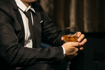 Businessmen in suits drinking whiskey