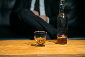 Businessmen in suits drinking whiskey