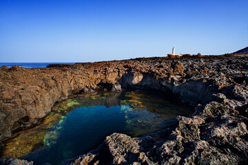 Fototapeta na wymiar View of the lava beach of Linosa Called Piscine