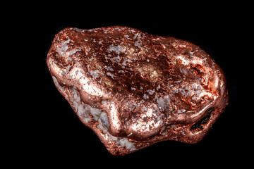 Macro mineral stone of a copper nugget on a microcline on a black background