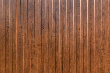 Profiled sheet fence with imitation of wood.