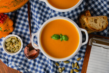 Homemade pumpkin soup with cream and basil