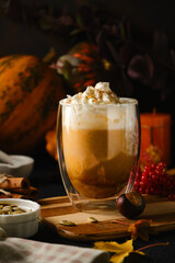 Pumpkin latte in a glasses. Autumn drink for Halloween or Thanksgiving.