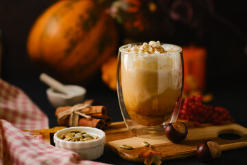 Pumpkin latte in a glasses. Autumn drink for Halloween or Thanksgiving.