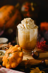 Pumpkin latte in a glasses. Autumn drink for Halloween or Thanksgiving.