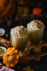Pumpkin latte in a glasses. Autumn drink for Halloween or Thanksgiving.