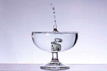 Dice falling into the water with splashes
