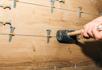 Professional tile laying. Placing or taking out special tile spacers with rubber...