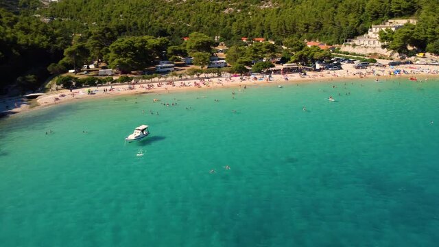 Turquoise Ocean With Several Vacationists At Prapratno Cove In Peljesac Peninsula, Southern Dalmatia, Croatia. Aerial Drone