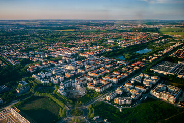 Fototapeta na wymiar Aerial view of Bussy Saint Georges, an eastern suburb of Paris in the new city of Marne La Vallée - Planned community with a grid street plan and modern residential areas surrounded by nature